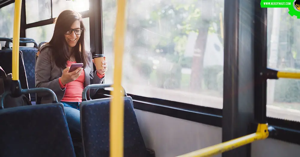 girl using phone while travelling in a bus