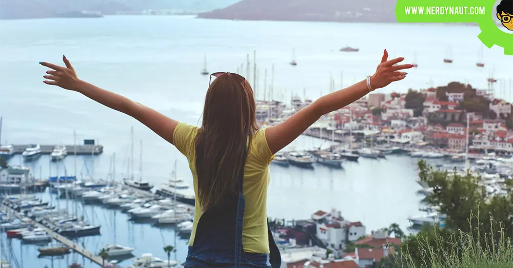Woman Raising Her Hands Facing Cityscape Near Body of Water - New Zealand