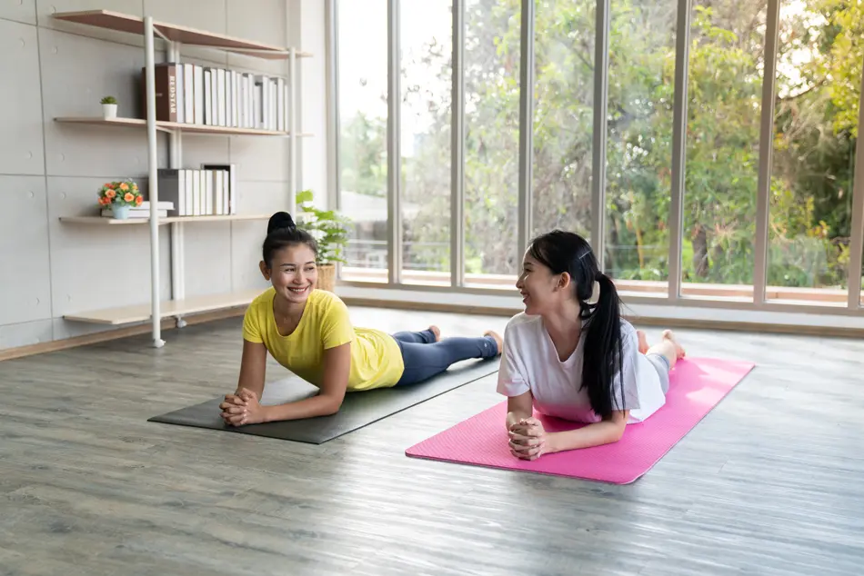 Yoga at home - two asian ladies on yoga mats