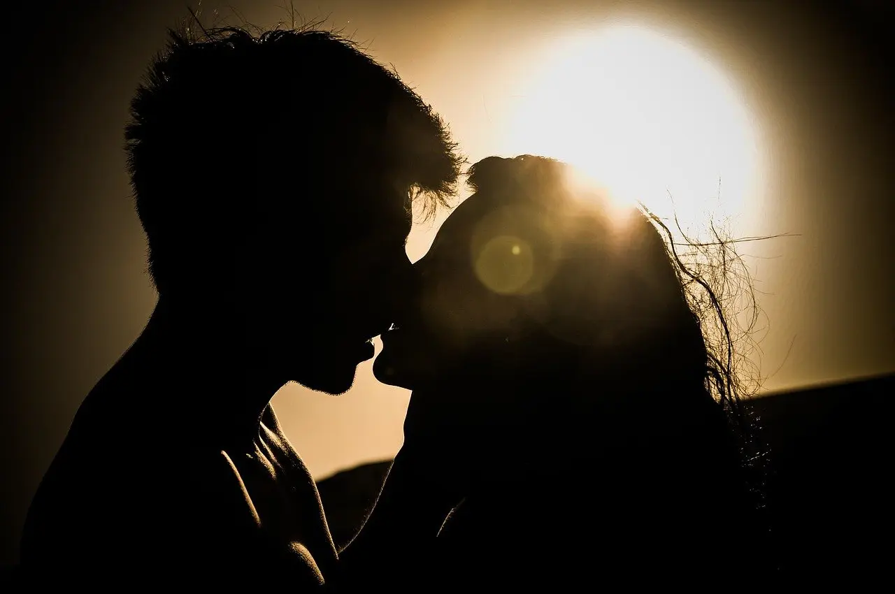 Couple kissing while sunset