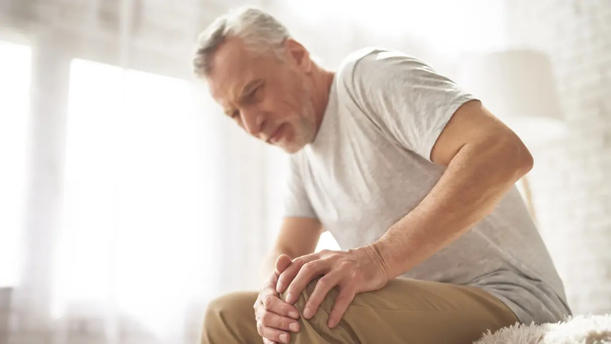 an elderly man with arthritis