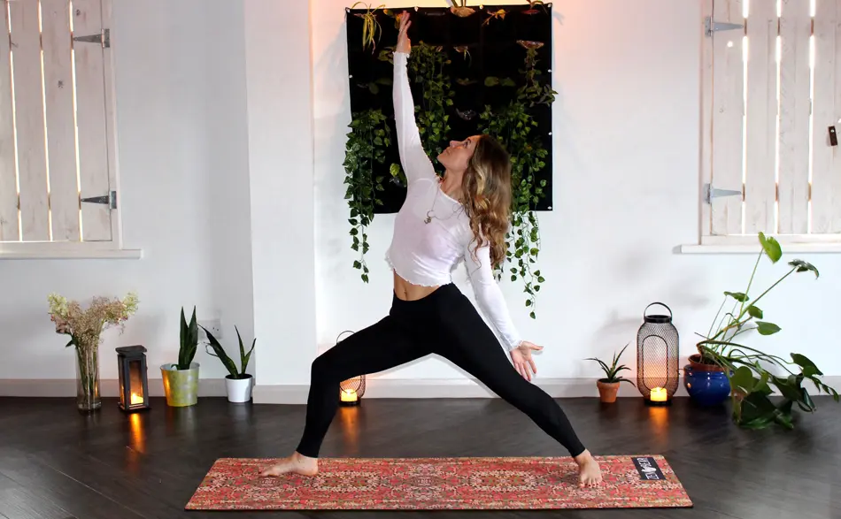 Girl doing yoga on a yoga mat at home