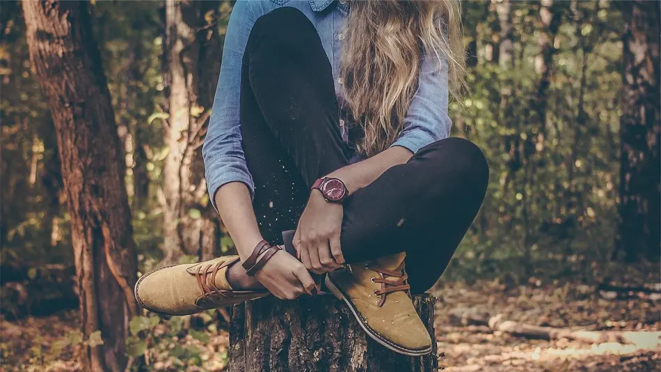 Girl wearing a watch in the woods