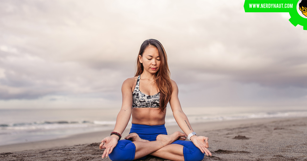 Woman doing yoga on the beach