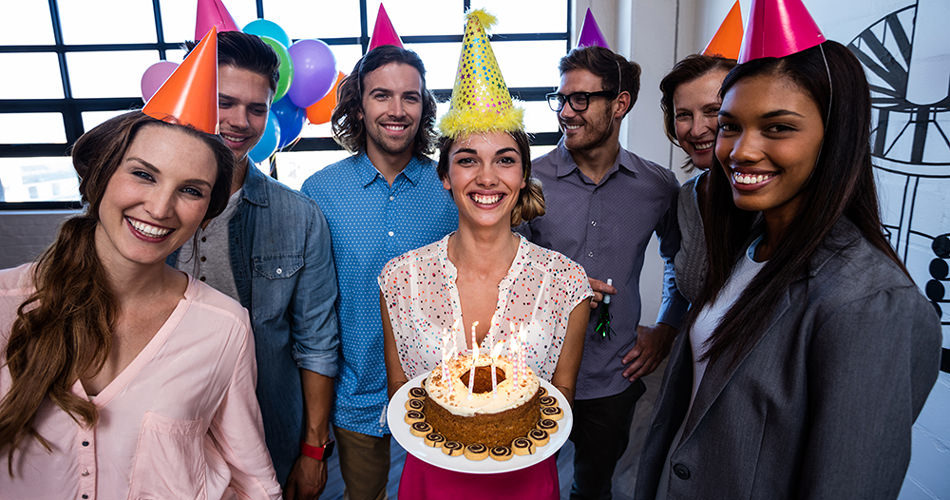 happy office employees celebrating employee birthday