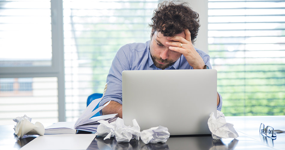 Overwhelmed man at office