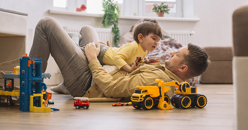 Dad playing with a son on the floor