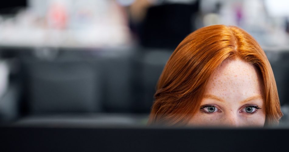 WOman watching a computer screen
