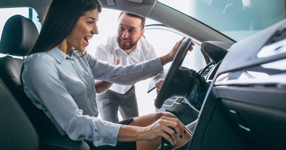 Car salesman showing a car to woman